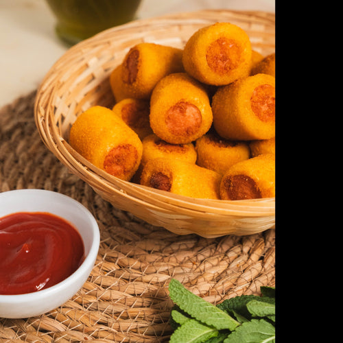 A party platter filled with golden mini Brazilian sausage rolls served hot, perfect for kids' parties and catering.