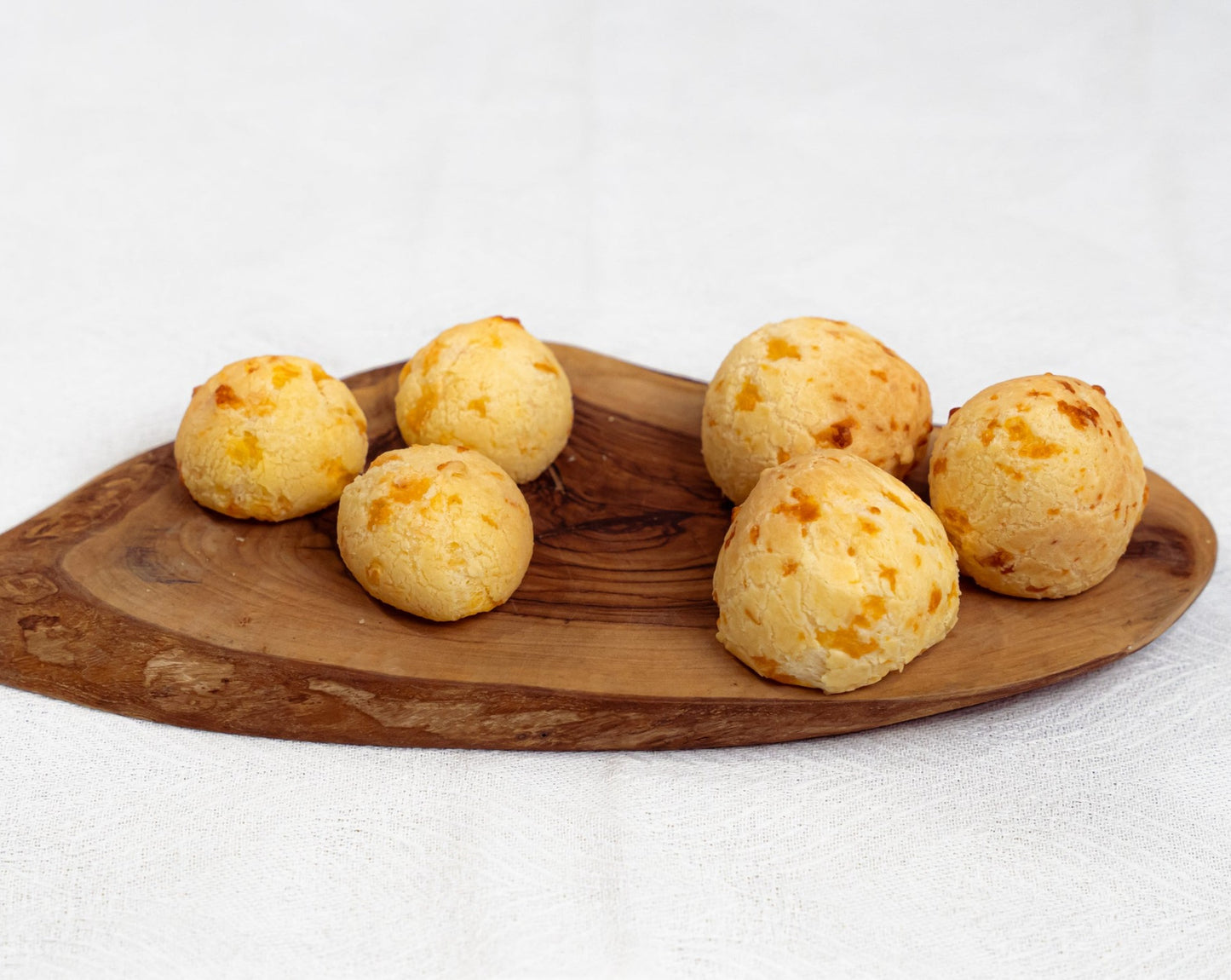 Pack of 100 cocktail size frozen Brazilian cheese bread or Pão de Queijo by Beth's, naturally gluten-free party snacks.